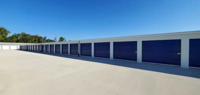 Wide aisle of blue drive-up storage doors at Midwest Indoor Storage in Austin, MN