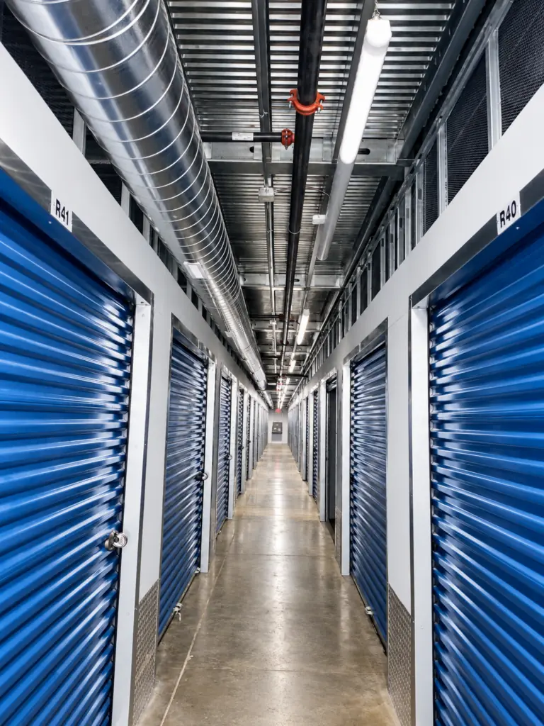 Indoor storage corridor with blue roll-up doors at Midwest Indoor Storage in Rochester North, MN